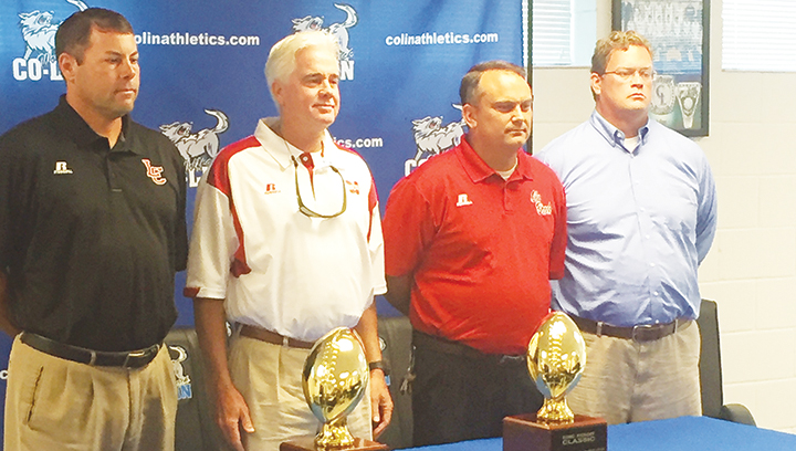 Photo by Anthony McDougle/ Lawrence County head coach Jaymie Palmer (left), Magee head coach Tim Coats, Ole Brook’s head coach Tommy Clopton and first-year Franklin County head coach Trey Woodard stand with the trophies that will be awarded to the winners of the first inaugural KDMC Kickoff Classic during a press conference Wednesday.
