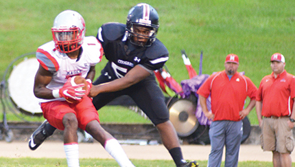Photo by Anthony McDougle/Lawrence County’s Terrance Stanfield (right) sacks Trojan QB Tyrique McAfee during the first half of action between the two teams.