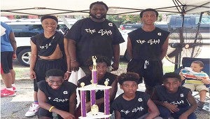 Photo submitted  Bottom row: Deovion Turner (left), Travien Mackabee, Deon Dixon ; Top row: Austin Alexander (left), Coach Glen Sanders and Josh Earl of The Shop took first place for the 11-14 year-old age group. Sanders also served as the Hoopfest organizer and host.