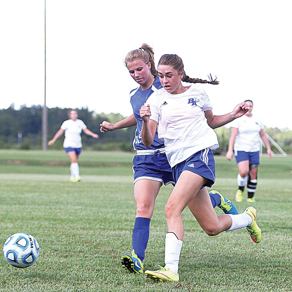 Photo by Sherylyn Evans /BA’s Madalyn Oglesby and Adams County Christian’s Bailey Boyd fight for possession in the Cougars’ 2-1 loss at home to the Rebels Wednesday night.