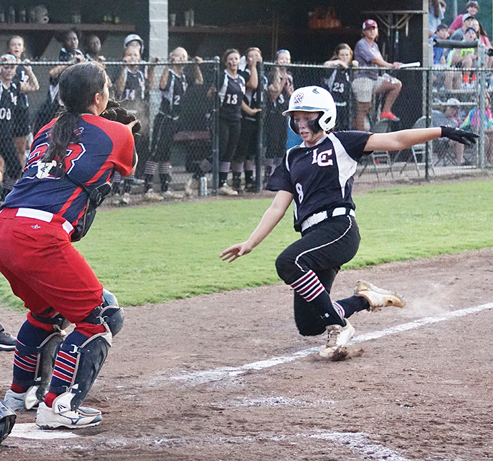 Photo by Jana Harp /Lawrence County’s Sydney Pevey attempts to beat the throw home to Ole Brook catcher Meg Foster during the Panthers’ 7-5 win over the Cougars in extra innings Thursday night.