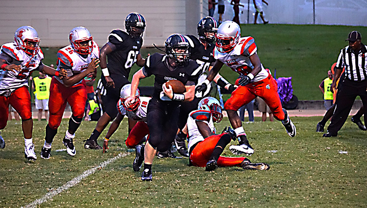 Photo by Jana Harp/ Lawrence County running back Brandon Bullock looks for room in the Cougars’ first game of the season against the Magee Trojans.