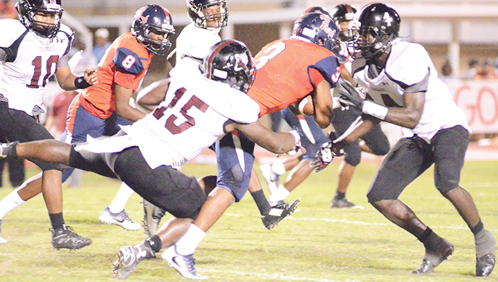 Photo by Anthony McDougle/ Ole Brook running back Kenneth Dixon is wrapped up by Lawrence County’s Marcus Atterberry during the two team’s game Friday night at King Field in Brookhaven.