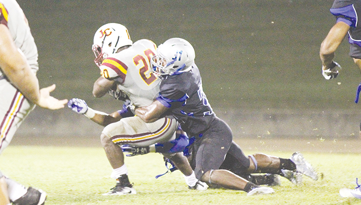 Photo by Amy Rhoads /JCJC running back Scott Phillips is wrapped up by Co-Lin defensive back Jaquarius Landrews in the Wolves’ win at home against the Bobcats Thursday.
