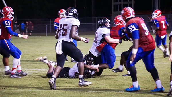 Photo by Jana Harp Lawrence County’s Oliver Moreman wraps up a Seminary runner in their game Friday.