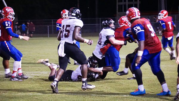 Photo  by Jana Harp  Lawrence County’s Oliver Moreman wraps up a Seminary runner in their game Friday. 