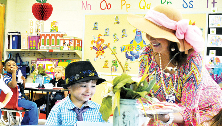 Photos by Aaron Paden/Four-year-old preschooler Pierce Porter takes a cookie served by teacher Macie Bateman Friday during the elegant elephant party.