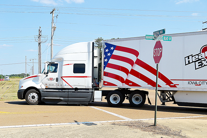 Photo by Donna Campbell/An 18-wheeler turns onto Manufacturers Boulevard West off Industrial Park Road to enter the Brookhaven Industrial Park Monday. The Lincoln County Board of Supervisors Monday chose Dungan Engineering to manage a $2.7 million repaving project to rebuild and repair Manufacturers Boulevard East and West and Fender Trail.