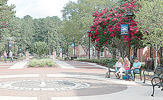 Photo by Johnny Smith/Students visit recently on one of the benches in the pedestrian corridor at Copiah-Lincoln Community College. A ribbon-cutting ceremony will be Thursday at 2:30 p.m.