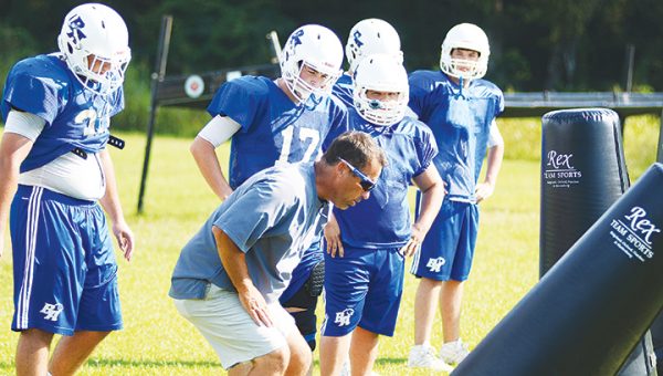 Photo by Anthony McDougle/ Brookhaven Academy head coach Ron Rushing explains a drill to some Cougar lineman during a practice.  