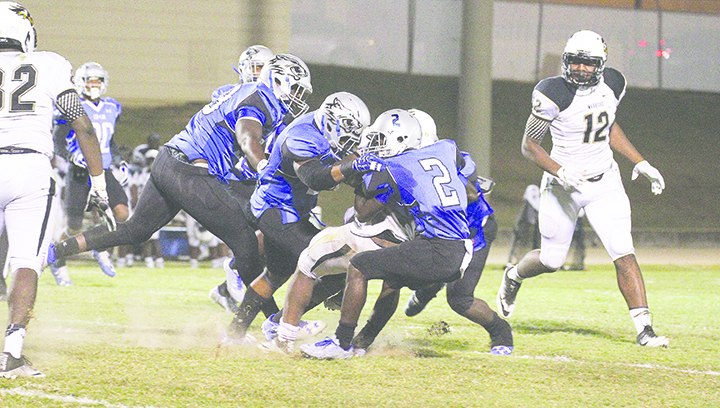 Photo by Lucas Calvert/Freshman Isaiah Swopes and a host of Wolves wrap up an East Central running back in a 34-23 win over the Warriors last week.