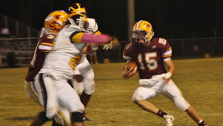 Photo by Christy Boyte/Zach Hodges for the Yellow Jackets (15) attempts to dodge a Trojan defender in Friday’s game.