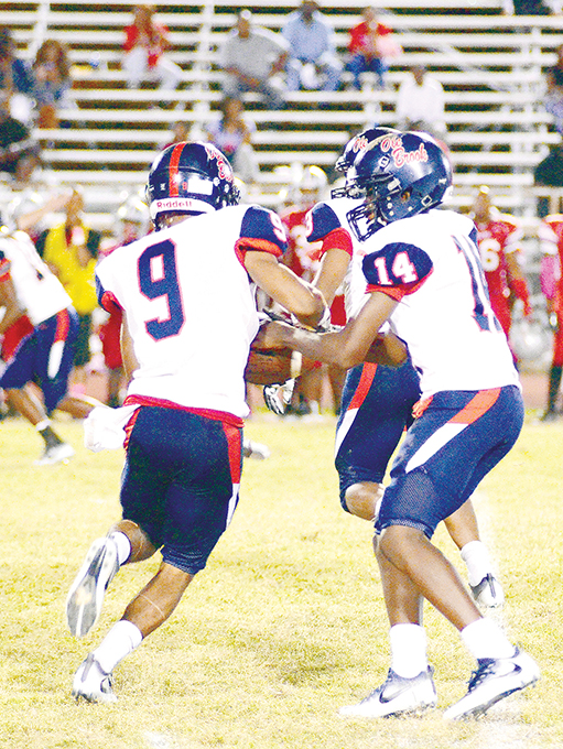 Photo by Anthony McDougle/Ole Brook’s freshman quarterback Byrion Robinson hands off to Don Blandon in the Panthers’ 13-0 district victory over the Provine Rams Thursday night at Hughes Field in Jackson.
