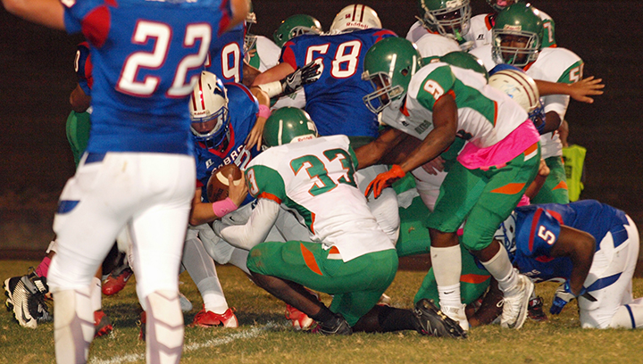 Photo by Tracey Fischer/Cobra quarterback Peyton Burns punches it in for the TD amidst a pile of players.