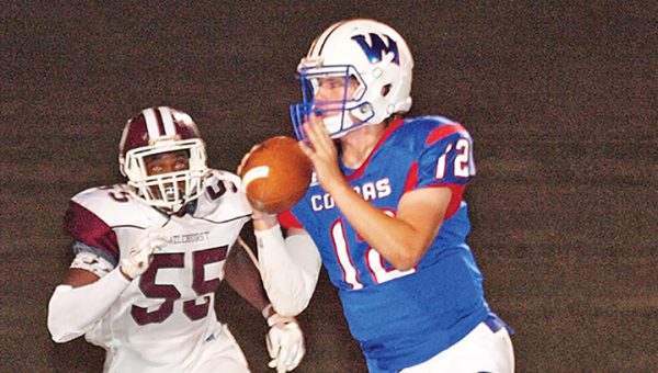 Photo by Tracy Fischer/ Wesson quarterback Petyon Burns attempts to evade a Hazlehurst rusher during their district game Friday night.  