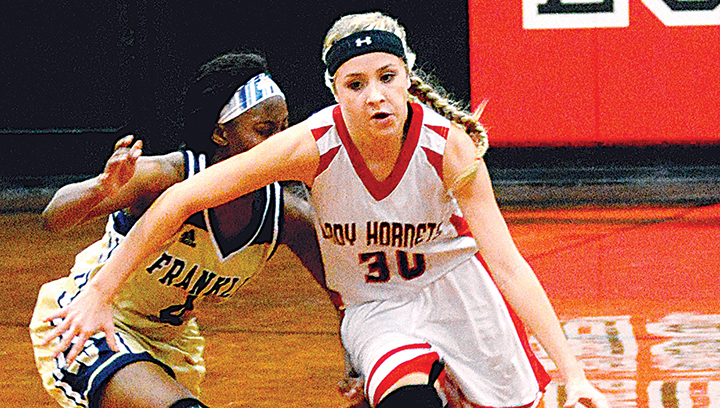 Photo by Chris King/Loyd Star’s Faith Bergeron fights off a Lady Bulldog defender Thursday as the Lady Hornets beat the Franklin County Lady Bulldogs.