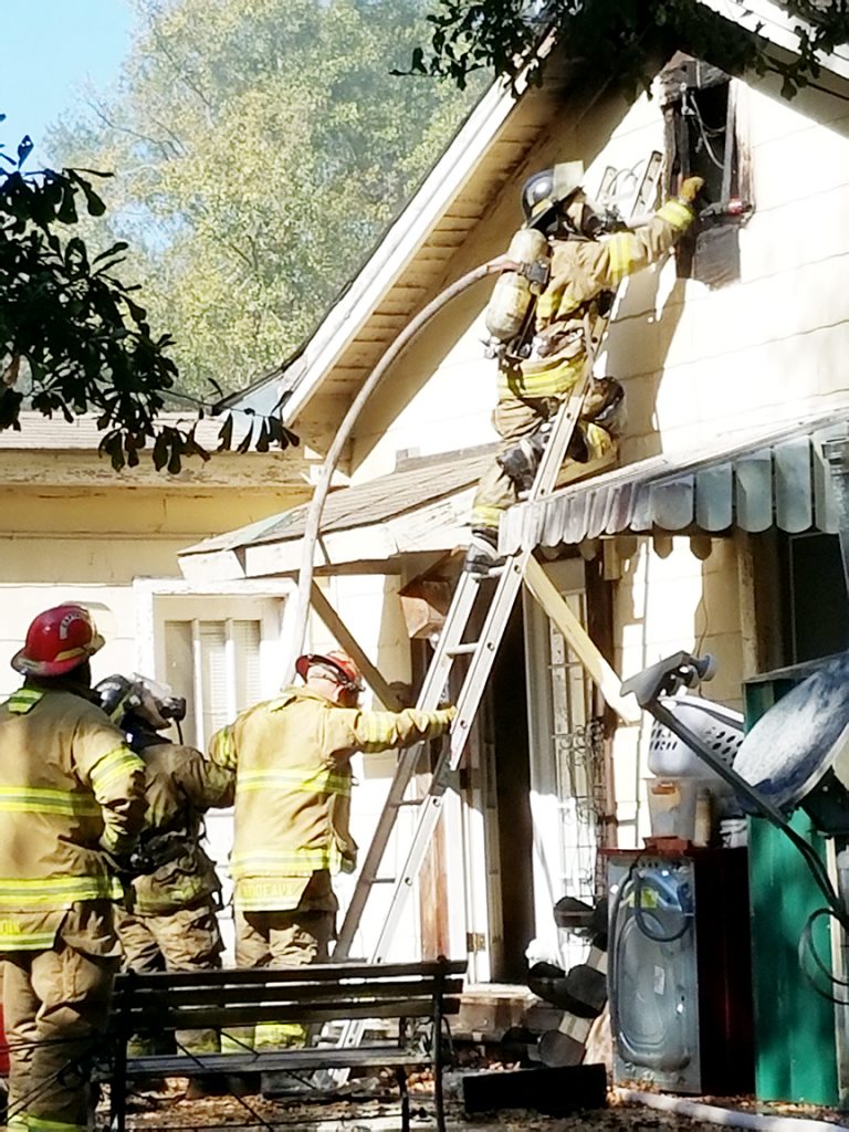 Photo by Donna Campbell/Brookhaven firefighters work to save a home at 1000 East Monticello St. shortly after 10 a.m. today.