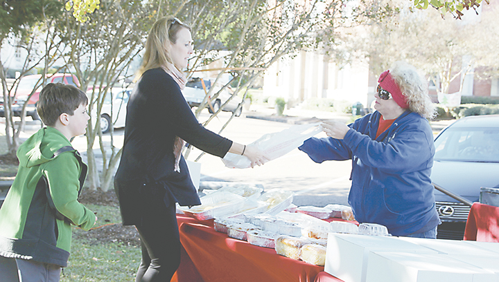 Photo by Alex Jacks/Shoppers visited the fifth annual Thanksgiving Farmers Market in downtown Brookhaven Tuesday, shopping for all the ingredients needed for a family feast. Local farmers and artisans displayed fresh winter produce, homemade treats and all the ingredients needed for a family feast for sale. Local musician Ralph Miller entertained visitors throughout the market with Christmas music.