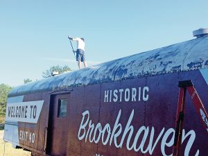 Photo submitted/The Brookhaven-Lincoln County Chamber of Commerce tourism council spent a year working toward transforming an old train car into a welcome sign for interstate travelers. A company was hired to pressure wash, prime, hand paint and clear coat the design to the train car.