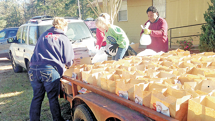 Photo submitted/Volunteers at the Doll’s House spent Saturday giving out more than 200 Thanksgiving boxes to local residents in need.