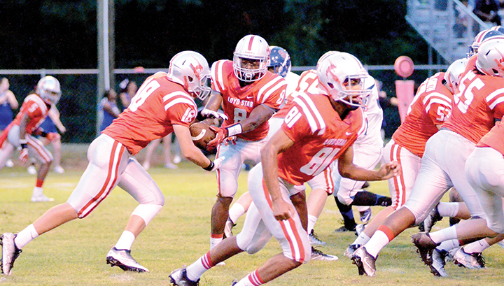 File photo/Loyd Star’s Michael Harvey hands the ball to Konner Allen during a previous game. The Hornets will face North Forrest in the first round of the playoffs tonight.