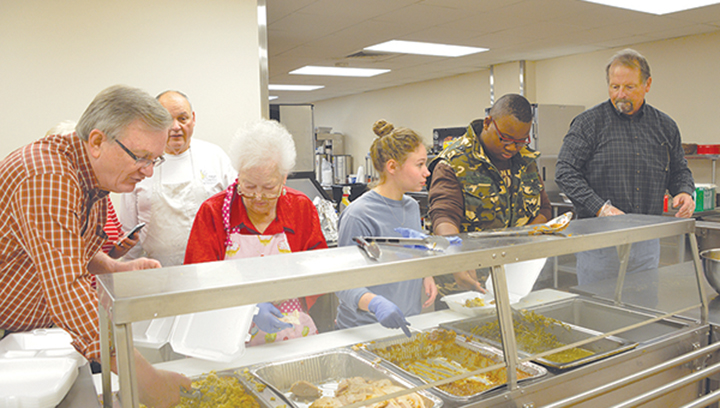 File photo/ Rev. Wayne Webster of First United Methodist Brookhaven (left) oversees a team of volunteers at a previous Doug Sullivan Community Thanksgiving Lunch held at the church’s Ministry Center. A free lunch will be served Thanksgiving day at the center from 11 a.m. to 1:30. Carryout meals and deliveries will be available.