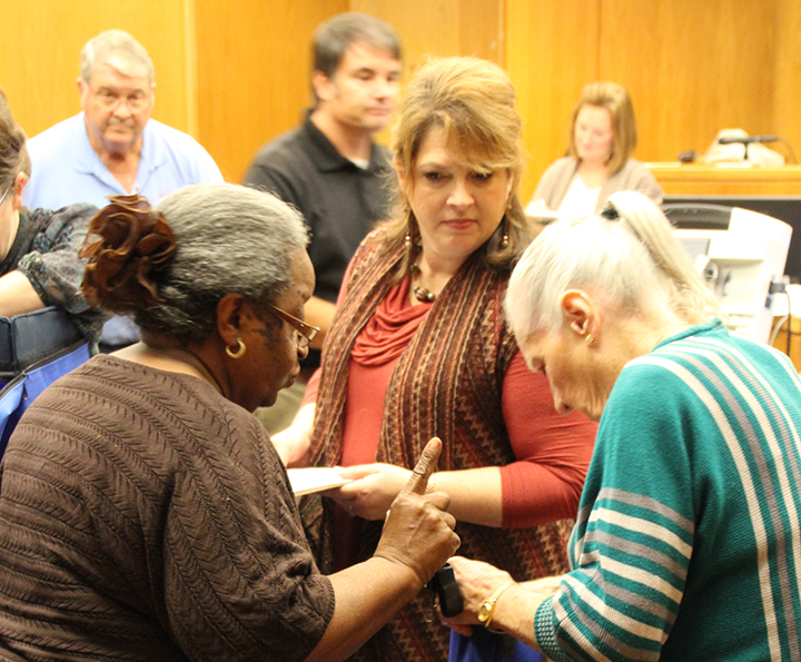 Photo by Alex Jacks/Election officials open a precinct box Tuesday night at the Lincoln County Government Complex.