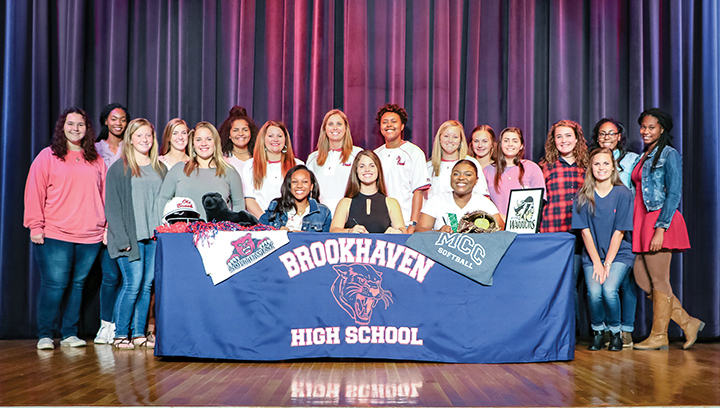 Submitted photo/Tia Bussey, Jada Henderson and Macy Ziskin signed letters of intent to play softball at the community college level Tuesday. They are surrounded by teammates and coaches at the signing ceremony.