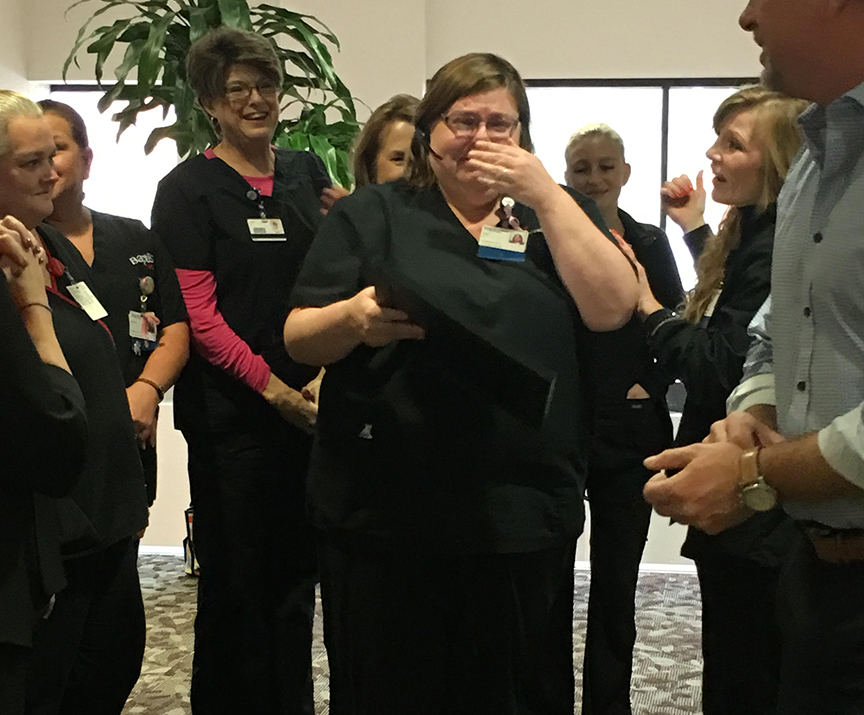 Jessica Breazeale with Reed’s Metals (left) and CEO Bernie Reed congratulates Lindy Donald on her win. She'll receive a new roof for her home in Richland.
