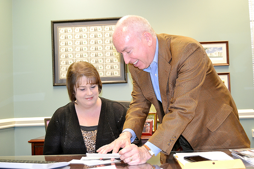 Photo by Donna Campbell/Bank of Brookhaven teller Bridget Thompson and President Shannon Aker add up some of the donations that have been received for the Holiday Food Pantry Drive. Donations will be accepted through Dec. 16.