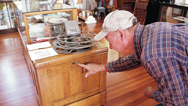 Photo by Alex Jacks / Harrell Montgomery examines an antique chest at the Lincoln County Historical Museum.