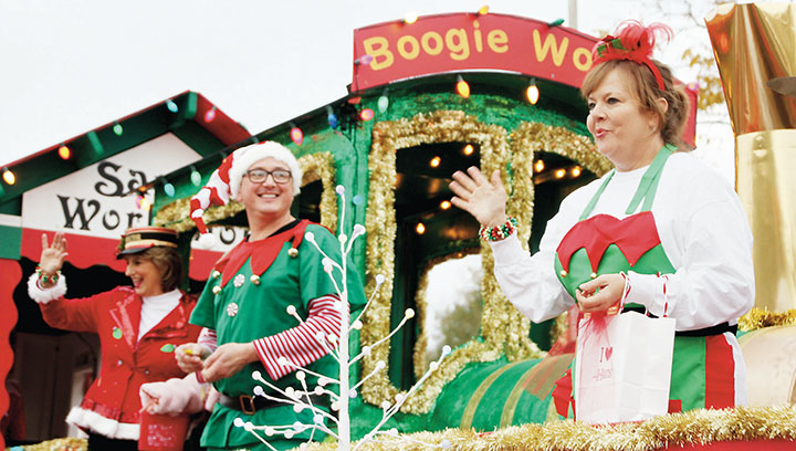 Photos by Alex Jacks/Employees of Hurst Review, of Brookhaven, entertained the parade crowds as elves in Santa’s Workshop. The float proved to be one of the biggest in the parade.