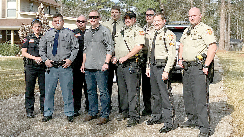 Photo submitted/First responders arrived Saturday at Mitchell and Amanda Chappell’s home in Brookhaven to welcome the injured trooper back to Brookhaven after months of hospital stays and rehab in Georgia. With Chappell (fourth from left) are Brookhaven Police offier Samantha Beach, Trooper Josh Leggett, Brookhaven Police officer Kyle Brady, and Lincoln County Sheriff’s deputies Barry Huff, Peter Griffin, Chuck Francis, Andrew Montgomery and Ian Smith.