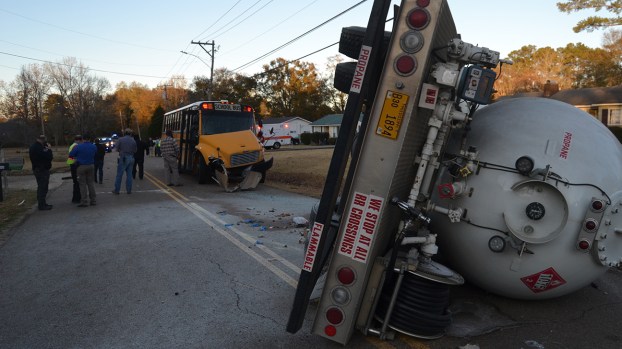 Propane truck overturns in crash with school bus; no injuries reported